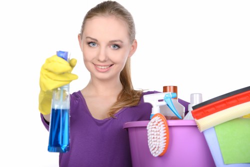 Office cleaning team sanitising desks and shared surfaces